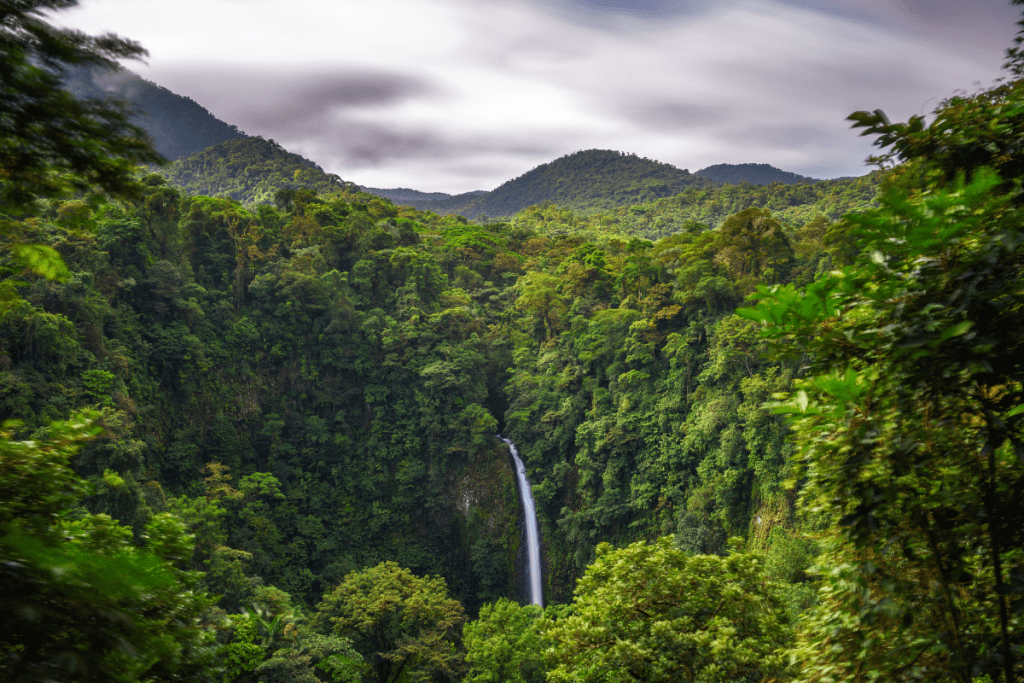 La Fortuna Waterfall from a distance during the rainy season in Costa Rica.