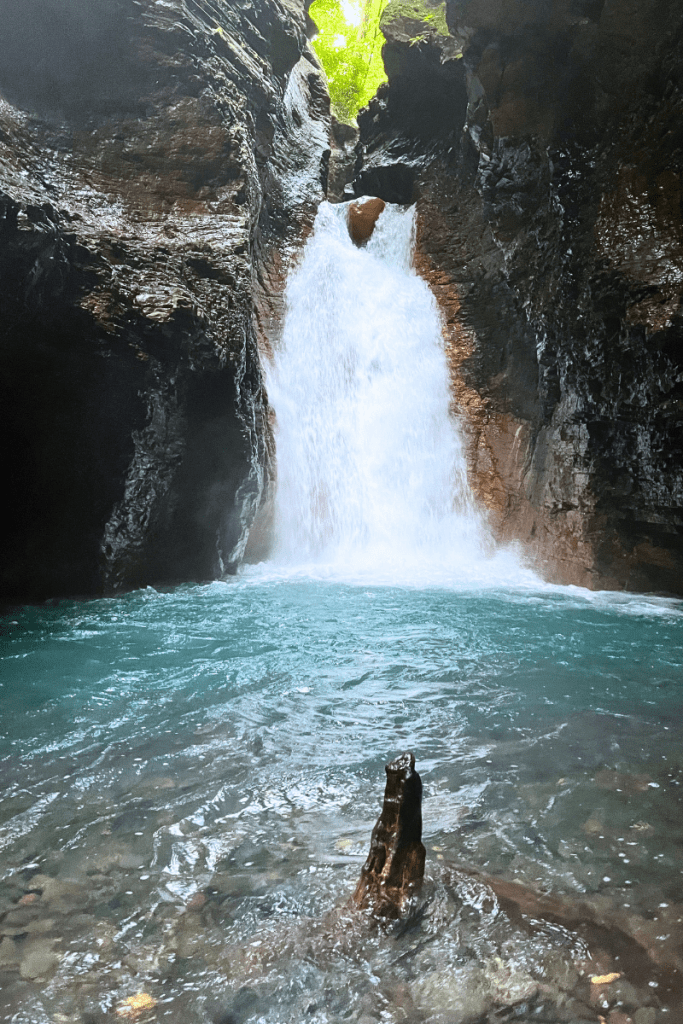 La Leona Waterfall with bright blue water from Rio Blanco coming from Volcano Rincon de la Vieja en Guanacaste, Costa Rica.